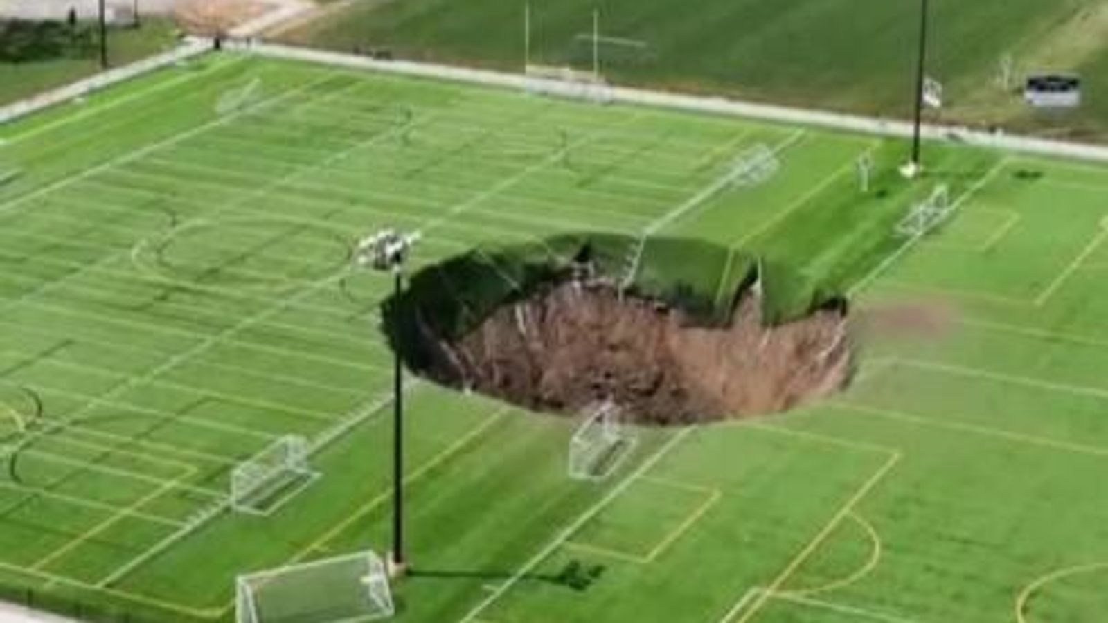 Huge sinkhole ‘100ft deep’ opens up in middle of Illinois football pitch | US News